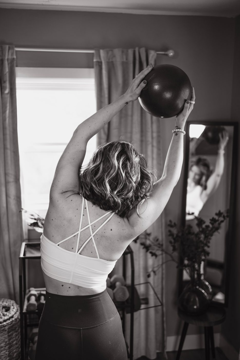 Heather reaching overhead with a ball