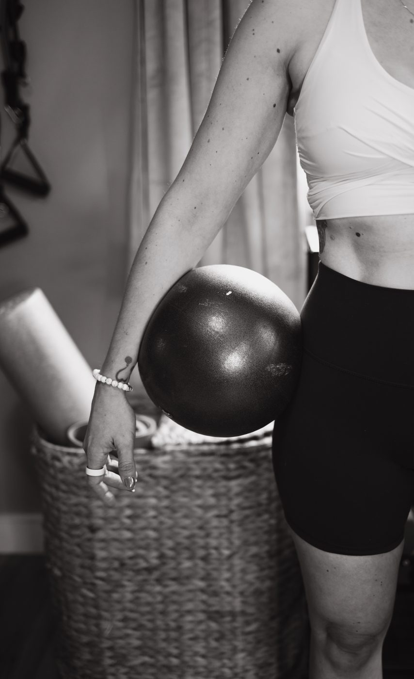 Heather holding a ball at her hip